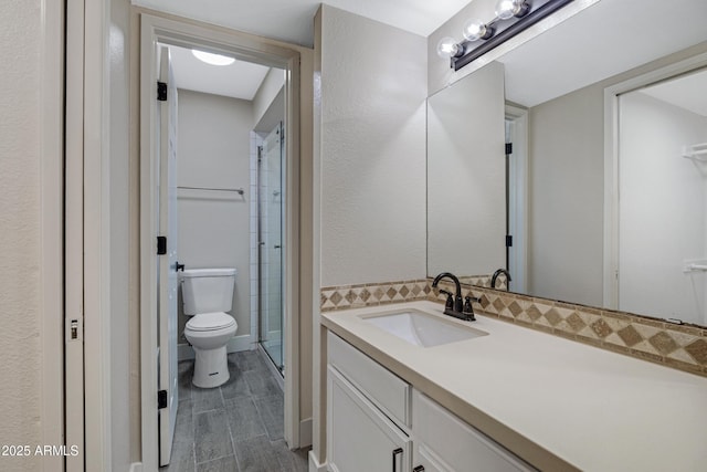 4165 E Huntington Dr, Phoenix, AZ 85040 - bathroom featuring toilet, wood finished floors, vanity, and a stall shower