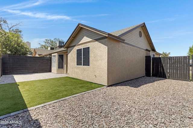 4165 E Huntington Dr, Phoenix, AZ 85040 - rear view of house with a patio area, stucco siding, fence, and a yard