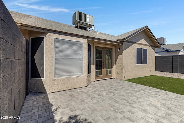 4165 E Huntington Dr, Phoenix, AZ 85040 - back of property featuring central air condition unit, french doors, fence, and stucco siding