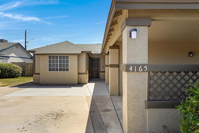 4165 E Huntington Dr, Phoenix, AZ 85040 - view of front of home featuring fence, a shingled roof, a gate, and stucco siding