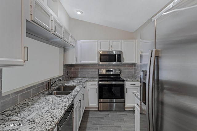 4165 E Huntington Dr, Phoenix, AZ 85040 - kitchen with white cabinets, decorative backsplash, stainless steel appliances, and a sink