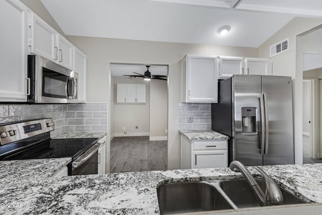4165 E Huntington Dr, Phoenix, AZ 85040 - kitchen with a sink, ceiling fan, appliances with stainless steel finishes, white cabinetry, and light stone countertops