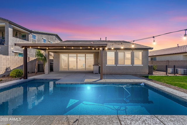 pool at dusk with a patio