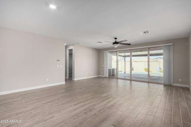 empty room featuring ceiling fan and light wood-type flooring