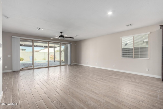 empty room with light hardwood / wood-style flooring and ceiling fan