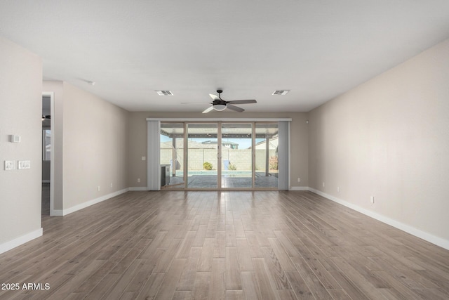 unfurnished room with hardwood / wood-style flooring and ceiling fan