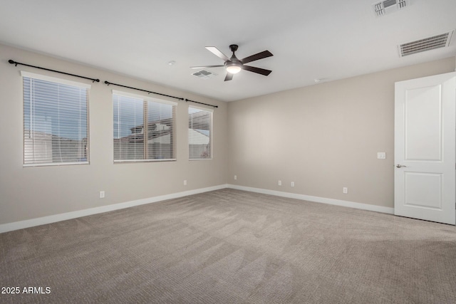 unfurnished room with ceiling fan and carpet