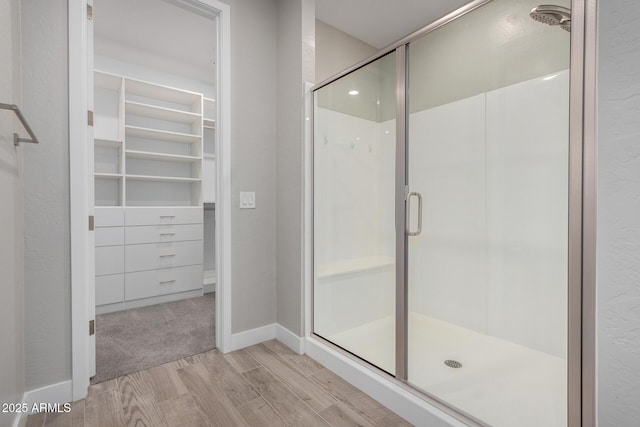 bathroom featuring walk in shower and hardwood / wood-style floors