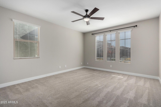 spare room featuring ceiling fan and carpet floors