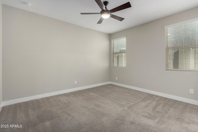 carpeted spare room with ceiling fan