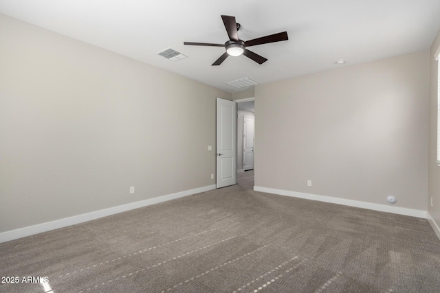 spare room featuring ceiling fan and carpet flooring