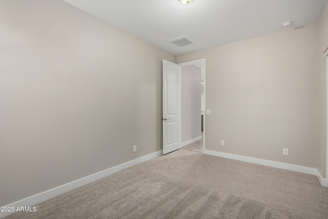 empty room featuring light carpet