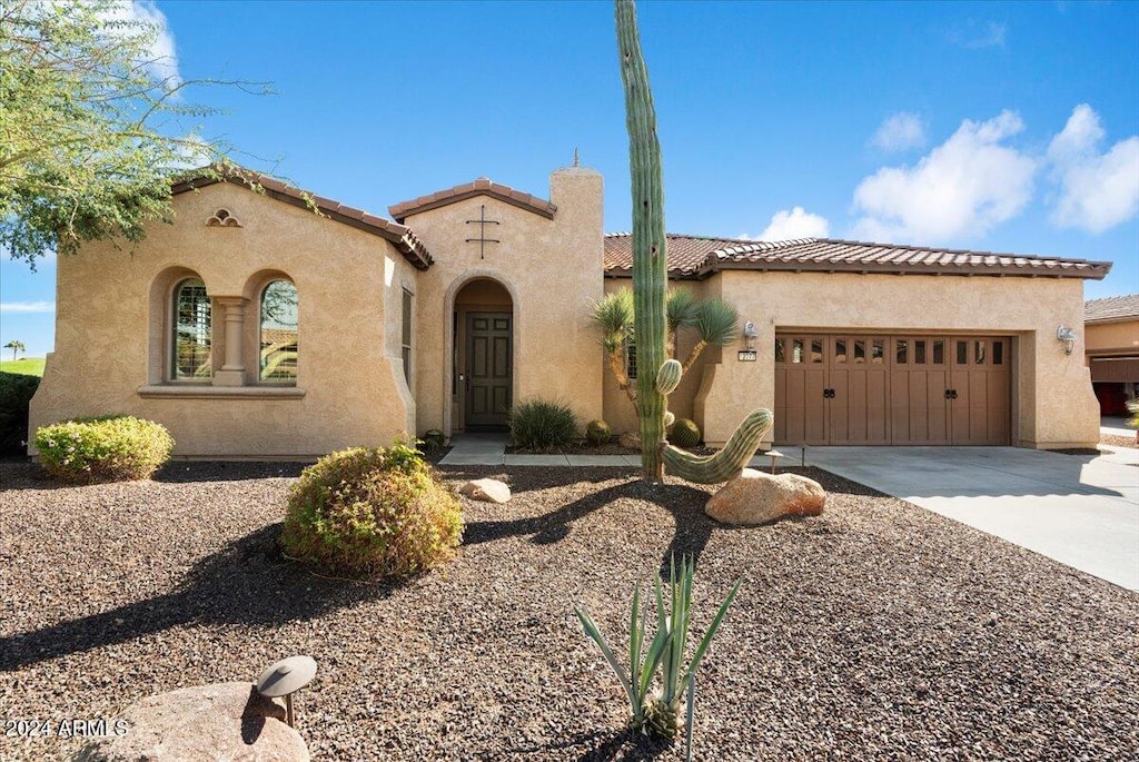 mediterranean / spanish house with a garage