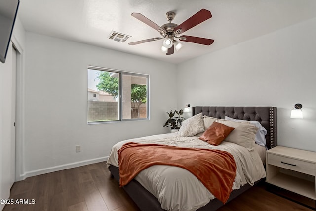 bedroom with visible vents, baseboards, a ceiling fan, and wood finished floors