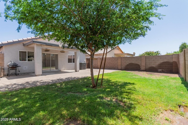 view of yard featuring a patio area and a fenced backyard
