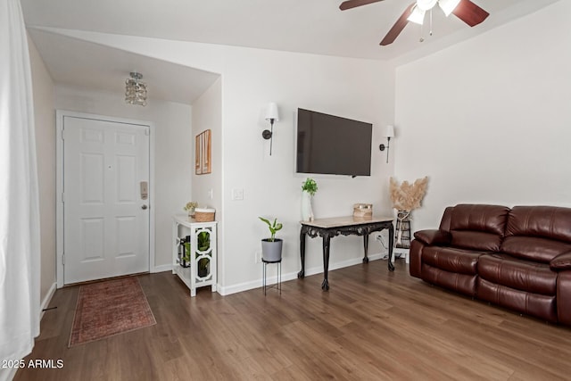 living room with baseboards, a ceiling fan, and wood finished floors