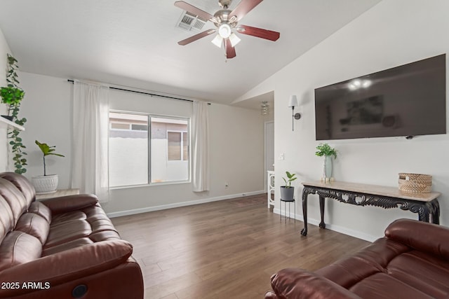 living area featuring a ceiling fan, visible vents, wood finished floors, lofted ceiling, and baseboards