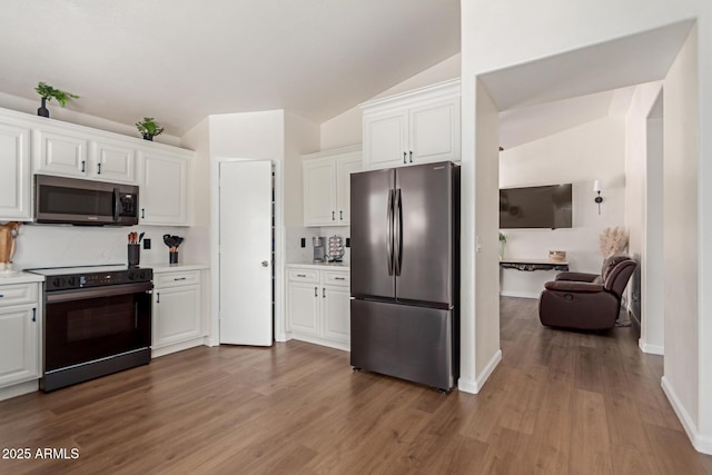 kitchen with dark wood finished floors, appliances with stainless steel finishes, light countertops, and white cabinetry