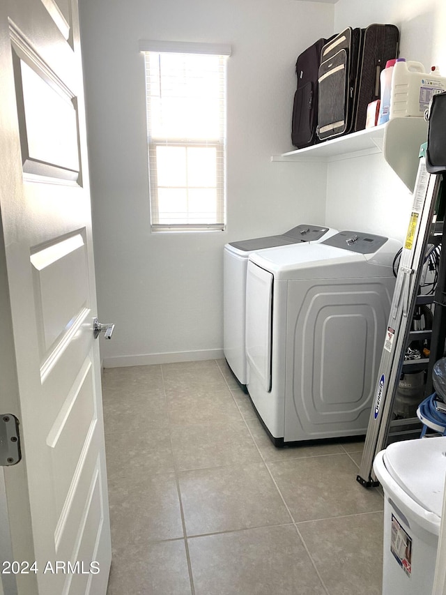 laundry area featuring separate washer and dryer and light tile patterned floors