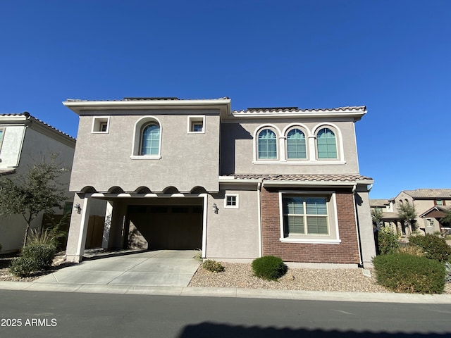 mediterranean / spanish home featuring a garage