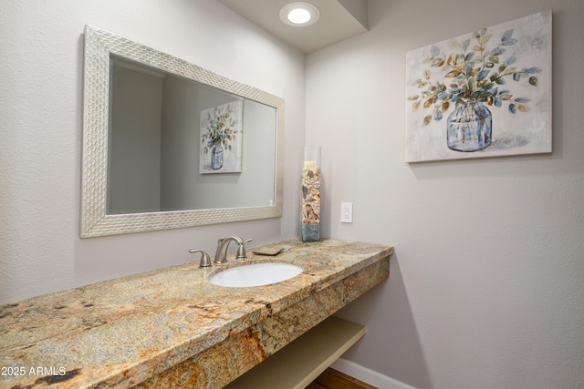 bathroom with vanity and baseboards
