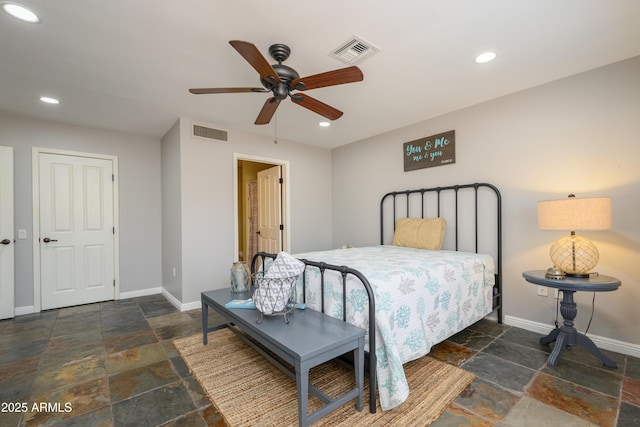 bedroom featuring visible vents, stone tile floors, and baseboards