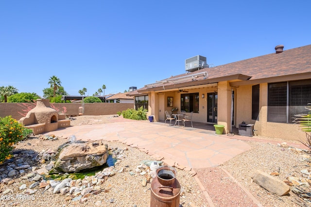 back of property with central AC unit, a fenced backyard, a patio area, and stucco siding
