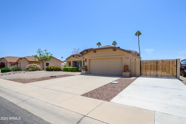 view of front facade featuring an attached garage, stucco siding, driveway, and fence