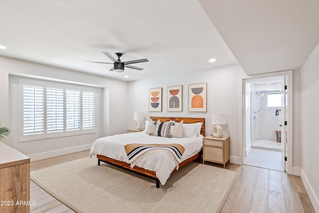 bedroom featuring ceiling fan, light hardwood / wood-style flooring, and ensuite bath