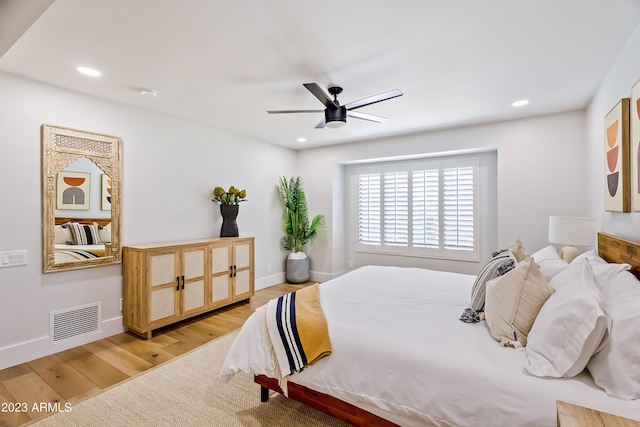 bedroom with light hardwood / wood-style flooring and ceiling fan