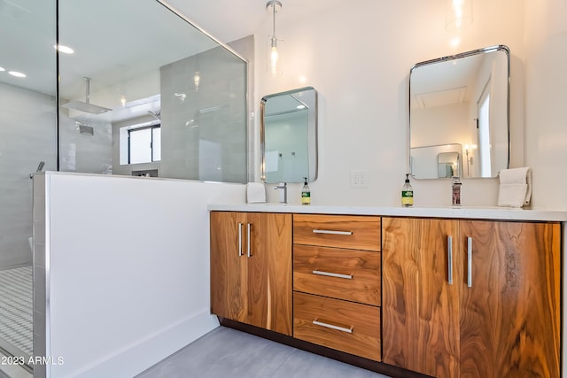 bathroom with tiled shower and vanity