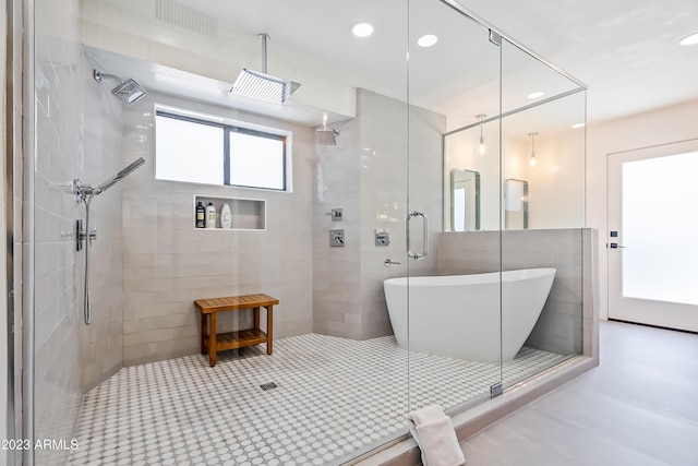 bathroom featuring tile patterned flooring and independent shower and bath