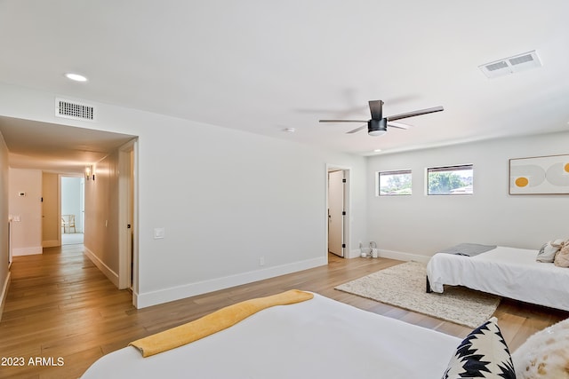 bedroom with ceiling fan and light hardwood / wood-style floors