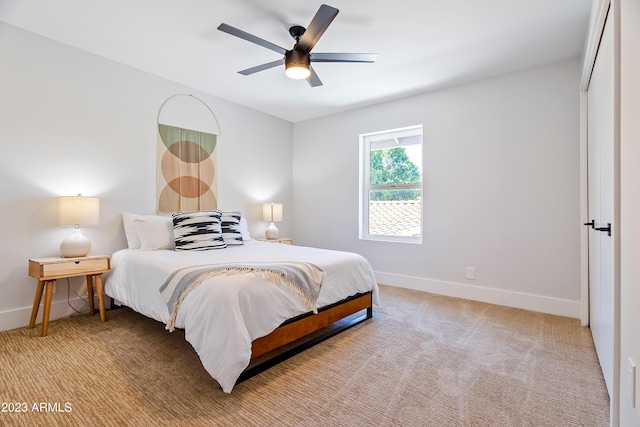 carpeted bedroom featuring a closet and ceiling fan