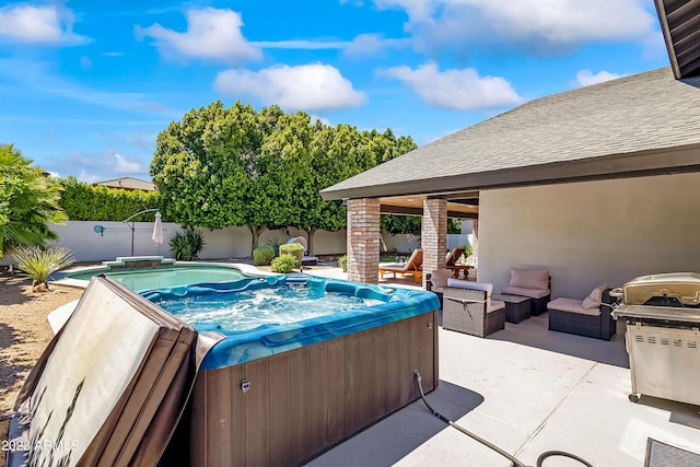 view of pool with an outdoor living space, a patio, and a hot tub