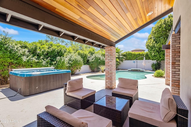 view of patio / terrace featuring outdoor lounge area and a pool with hot tub