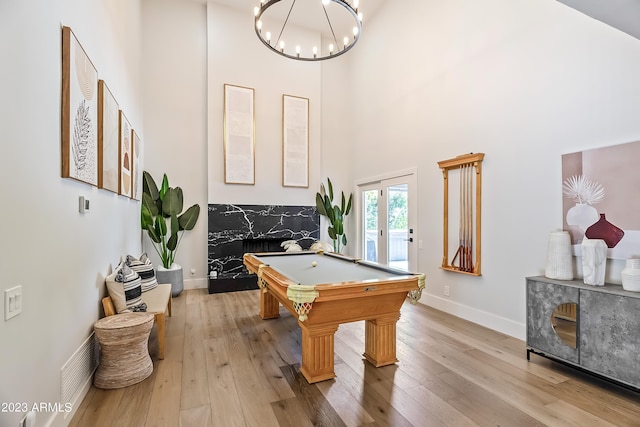 playroom with french doors, a high ceiling, billiards, and light hardwood / wood-style flooring