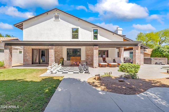 back of property featuring a yard, a patio area, and outdoor lounge area