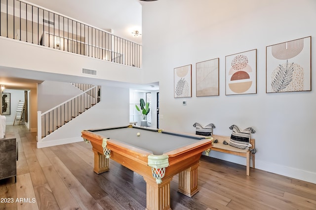 rec room featuring wood-type flooring, pool table, and a high ceiling