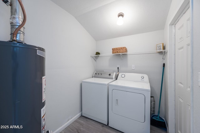 4207 W Culver St, Phoenix, AZ 85009 - laundry area with gas water heater, washing machine and clothes dryer, wood finished floors, and baseboards
