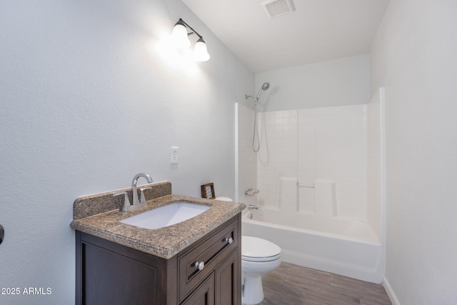 4207 W Culver St, Phoenix, AZ 85009 - bathroom with toilet, wood finished floors, vanity, and washtub / shower combination