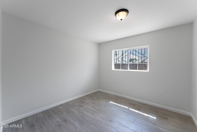4207 W Culver St, Phoenix, AZ 85009 - empty room featuring baseboards and wood finished floors
