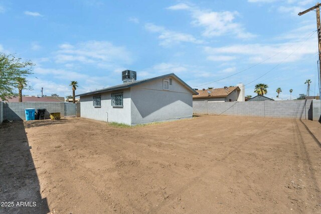 4207 W Culver St, Phoenix, AZ 85009 - rear view of property featuring central AC, stucco siding, and a fenced backyard