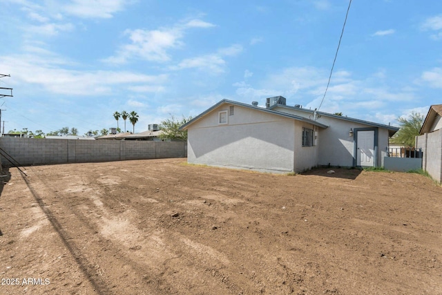 4207 W Culver St, Phoenix, AZ 85009 - rear view of property with fence and stucco siding