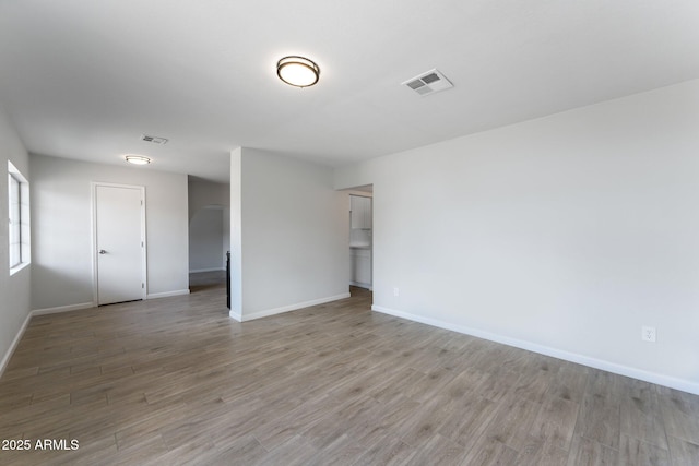 4207 W Culver St, Phoenix, AZ 85009 - spare room featuring light wood-style flooring, baseboards, and arched walkways