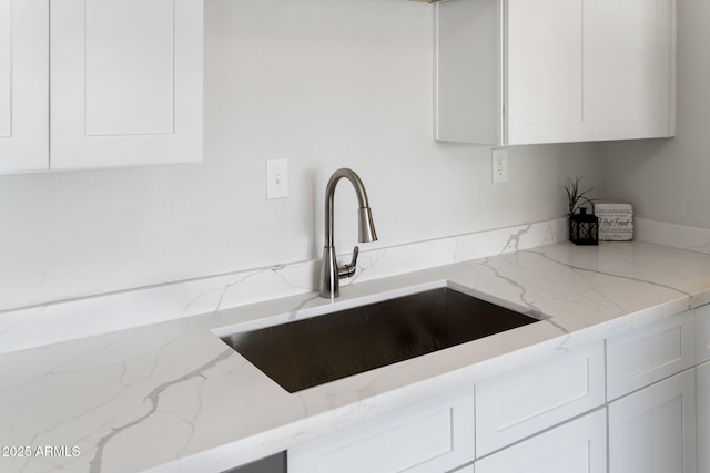 4207 W Culver St, Phoenix, AZ 85009 - kitchen view of a sink, white cabinets, and light stone counters
