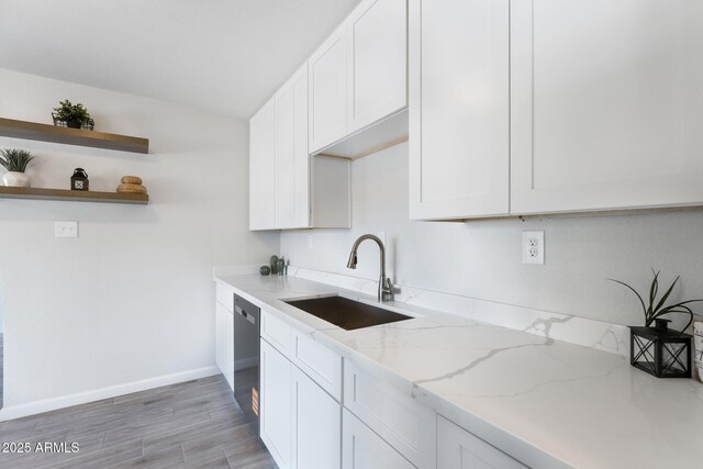 4207 W Culver St, Phoenix, AZ 85009 - kitchen featuring a sink, white cabinetry, light stone counters, open shelves, and light wood finished floors