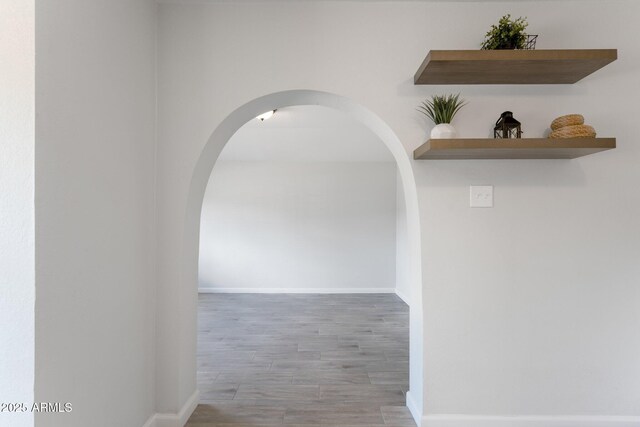 4207 W Culver St, Phoenix, AZ 85009 - corridor featuring wood finished floors, baseboards, and arched walkways