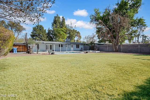 view of yard with a fenced in pool and a patio