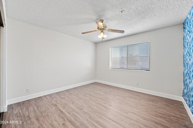 unfurnished room featuring a textured ceiling, wood-type flooring, and ceiling fan